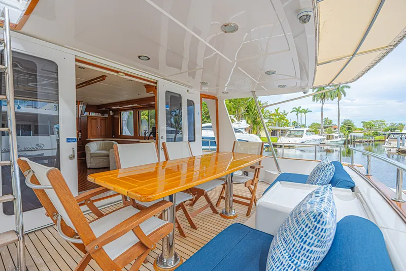 Slide: The Image of Luxurious 2005 Grand Banks 72 Aleutian RP yacht with elegant outdoor seating and dining area. - 15