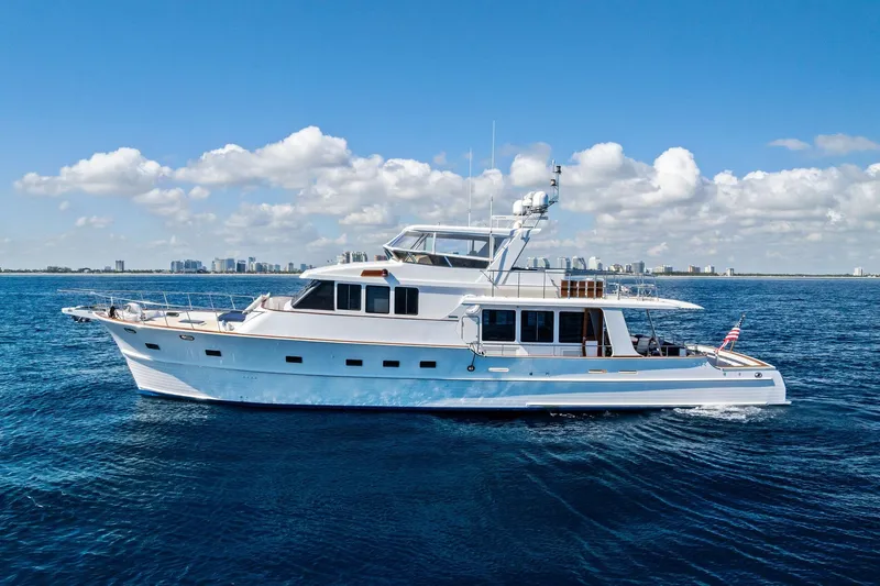 Slide: The Image of 2005 Grand Banks 72 Aleutian RP yacht cruising on open sea under clear blue sky. - 28