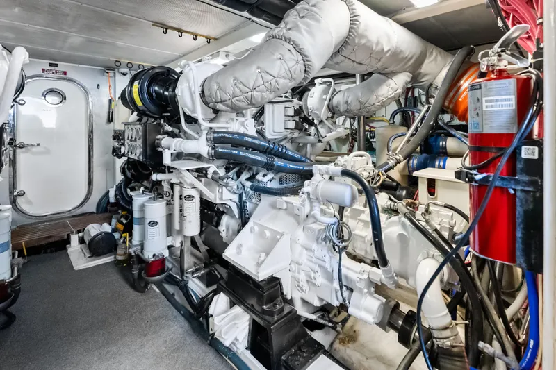 Slide: The Image of Engine room of 2005 Grand Banks 72 Aleutian RP yacht, featuring complex machinery and equipment. - 150