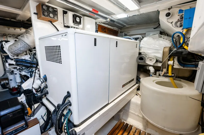 Slide: The Image of Engine room of 2005 Grand Banks 72 Aleutian RP yacht, featuring generator and equipment. - 144