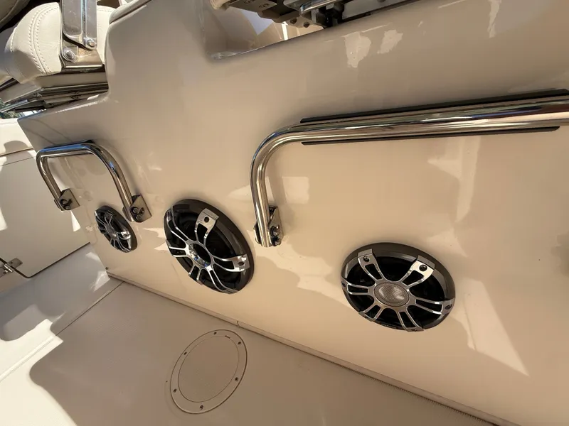 Slide: The Image of Close-up of speakers and grab rails on a boat, likely a Grady-White Canyon 306. - 21