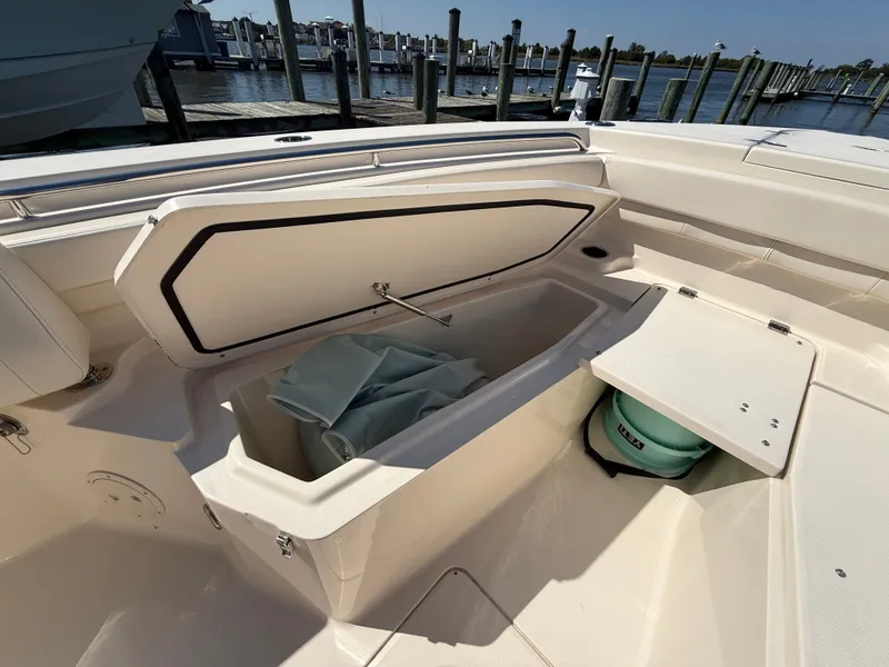 Slide: The Image of The image shows the storage area of a 2022 Grady-White Canyon 306 boat. - 24