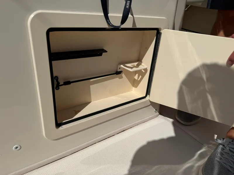Slide: The Image of An open storage compartment on a 2022 Grady-White Canyon 306 boat. - 30