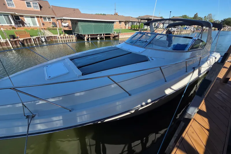 Slide: The Image of 1997 Regal Commodore 402 yacht docked by waterfront homes. - 9