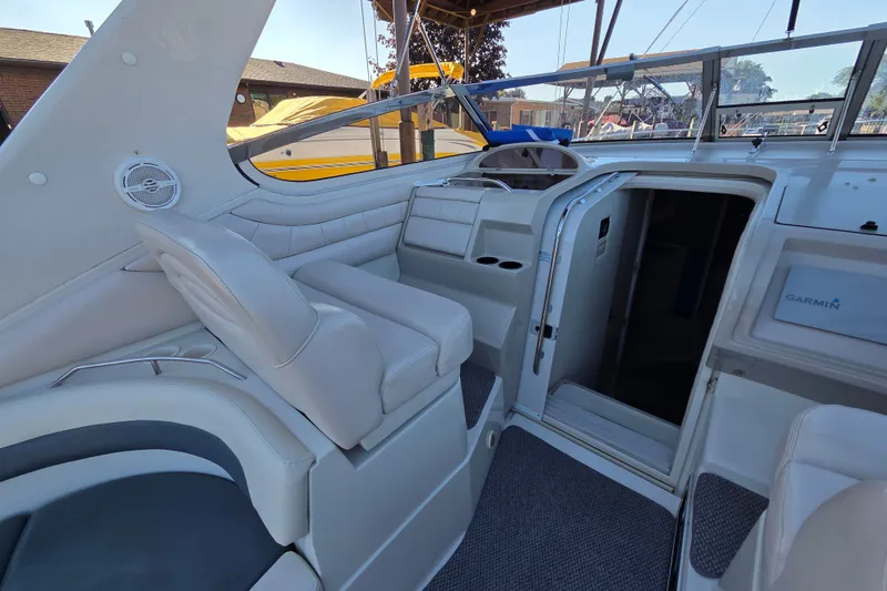 Slide: The Image of Interior of a 1997 Regal Commodore 402 boat, featuring white seating and a Garmin navigation system. - 17