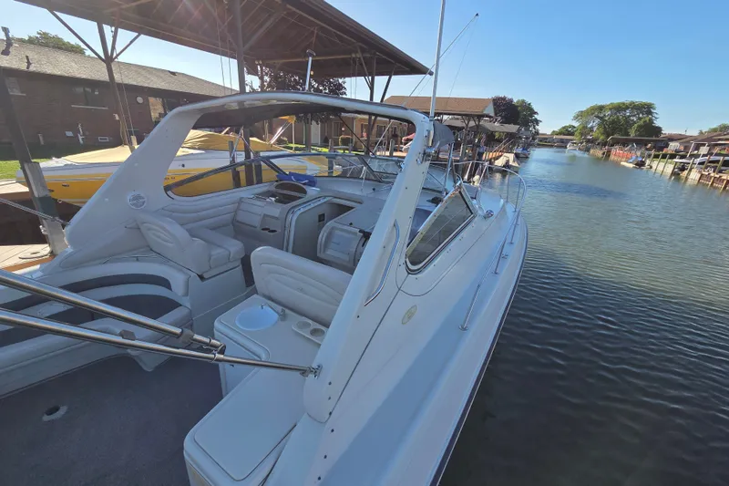 Slide: The Image of 1997 Regal Commodore 402 yacht docked in a serene canal setting. - 6