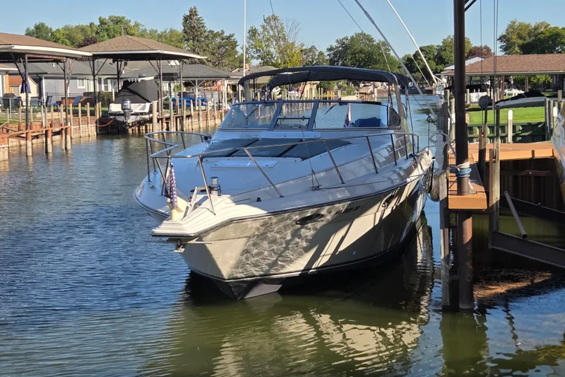 Slide: The Image of 1997 Regal Commodore 402 yacht docked in a serene marina setting. - 3