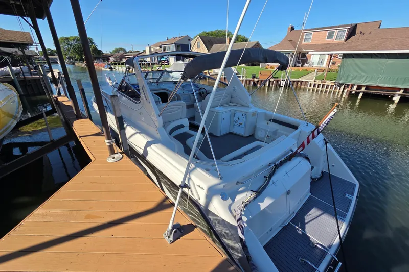 Slide: The Image of 1997 Regal Commodore 402 boat docked at a marina, featuring spacious seating and canopy. - 4