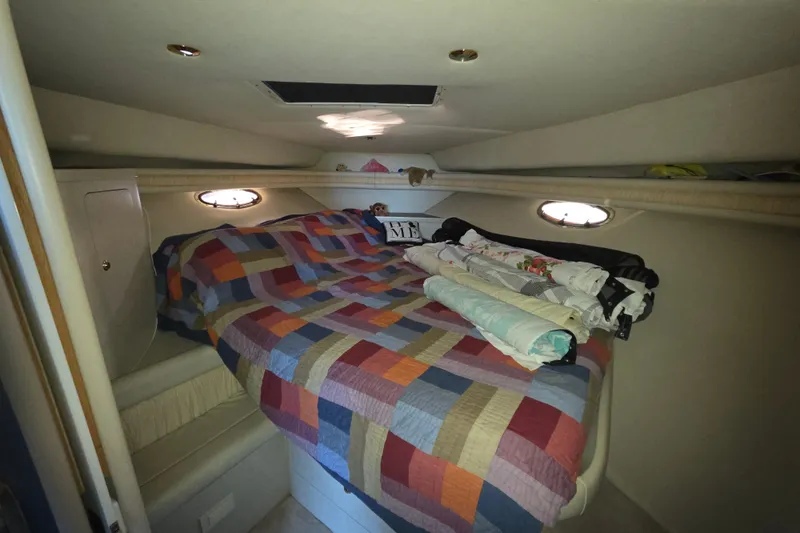 Slide: The Image of Cozy cabin interior of 1997 Regal Commodore 402 with colorful quilted bedspread. - 34