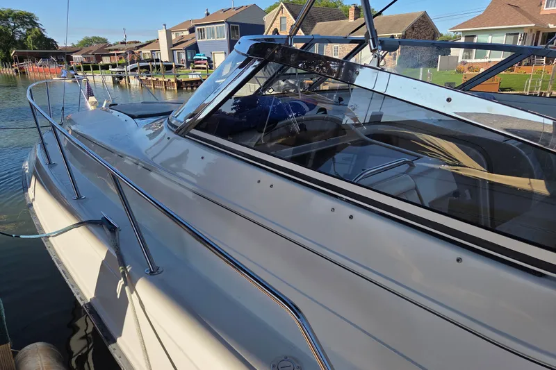 Slide: The Image of 1997 Regal Commodore 402 yacht docked by waterfront homes. - 7