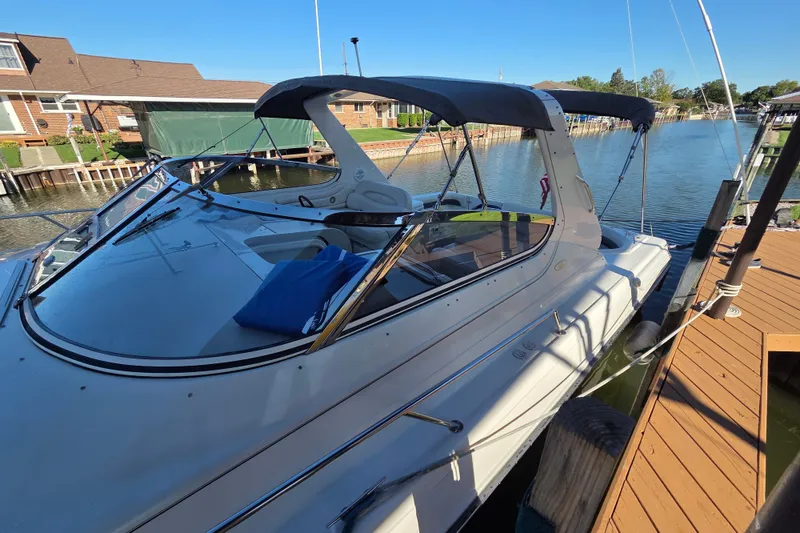 Slide: The Image of 1997 Regal Commodore 402 boat docked by a wooden pier on a sunny day. - 8