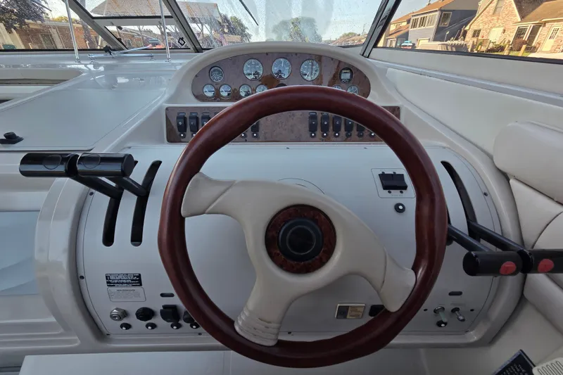 Slide: The Image of Steering wheel and dashboard of a 1997 Regal Commodore 402 boat. - 20