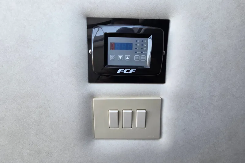 Slide: The Image of Control panel and switches on a 1997 Regal Commodore 402 yacht interior wall. - 24