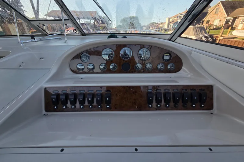Slide: The Image of 1997 Regal Commodore 402 boat dashboard with gauges and control switches. - 19