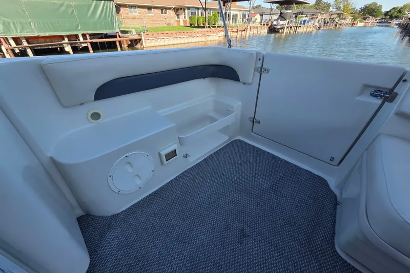 Slide: The Image of Interior view of a 1997 Regal Commodore 402 boat, featuring seating and storage. - 10