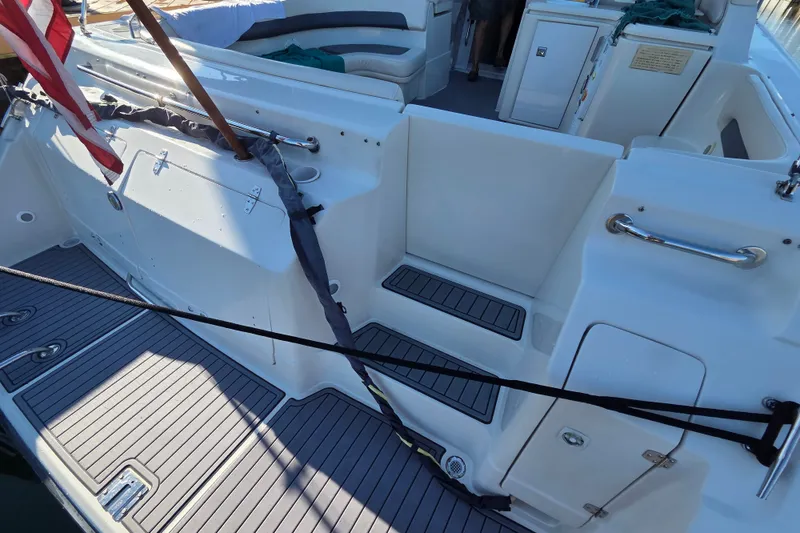 Slide: The Image of 1997 Regal Commodore 402 boat interior with seating and storage compartments. - 12