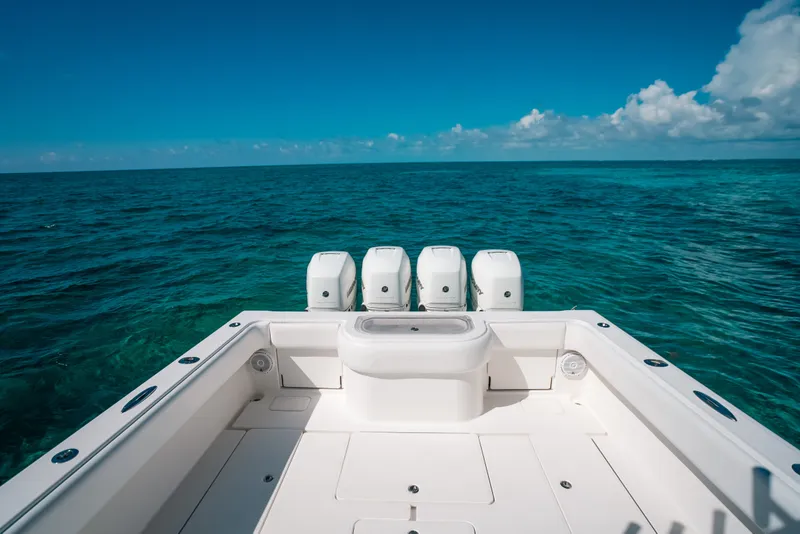 Slide: The Image of 2013 Invincible 42 Open Fisherman boat on clear ocean waters under blue sky. - 38