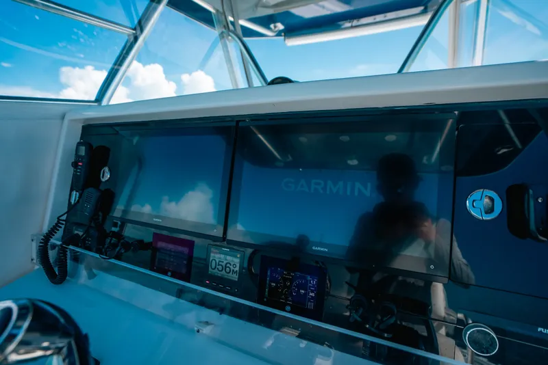 Slide: The Image of Cockpit of 2013 Invincible 42 Open Fisherman with Garmin navigation displays. - 30