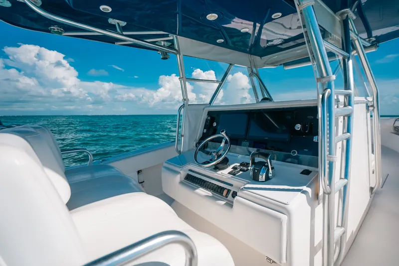 Slide: The Image of 2013 Invincible 42 Open Fisherman boat helm with ocean view and clear skies. - 27