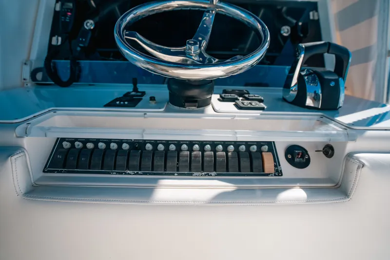 Slide: The Image of Control panel of a 2013 Invincible 42 Open Fisherman boat with steering wheel. - 29
