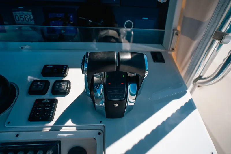 Slide: The Image of Control panel of a 2013 Invincible 42 Open Fisherman boat, featuring throttle and switches. - 32