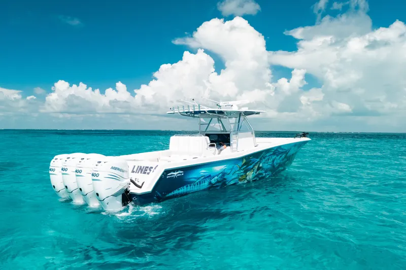 Slide: The Image of 2013 Invincible 42 Open Fisherman boat on clear turquoise water under blue sky. - 19