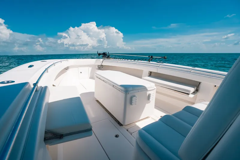 Slide: The Image of 2013 Invincible 42 Open Fisherman boat on open sea, clear skies, spacious deck. - 51