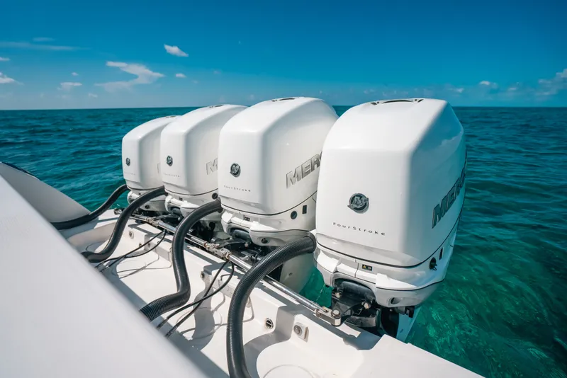 Slide: The Image of Four powerful outboard motors on a 2013 Invincible 42 Open Fisherman boat in clear ocean waters. - 43