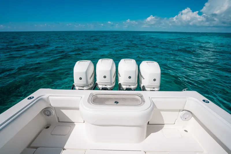 Slide: The Image of Invincible 42 Open Fisherman 2013 boat with four engines on clear ocean water. - 42