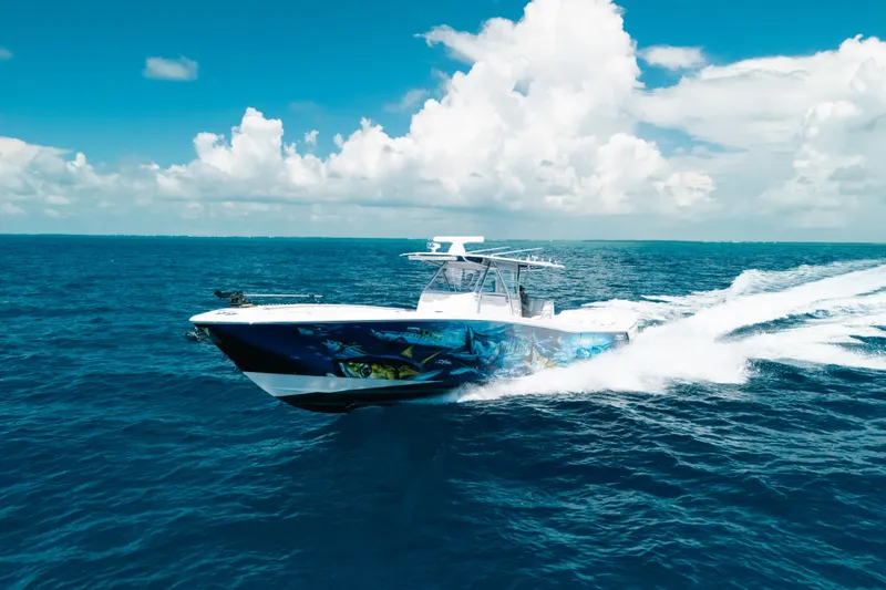 Slide: The Image of 2013 Invincible 42 Open Fisherman speeding on open ocean under clear blue sky. - 17