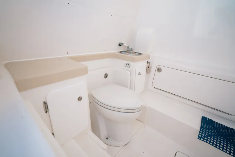 Slide: The Image of Bathroom interior of 2013 Invincible 42 Open Fisherman boat, featuring toilet and sink. - 58