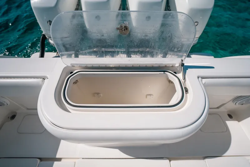 Slide: The Image of Open storage compartment on 2013 Invincible 42 Open Fisherman boat, with clear lid. - 45