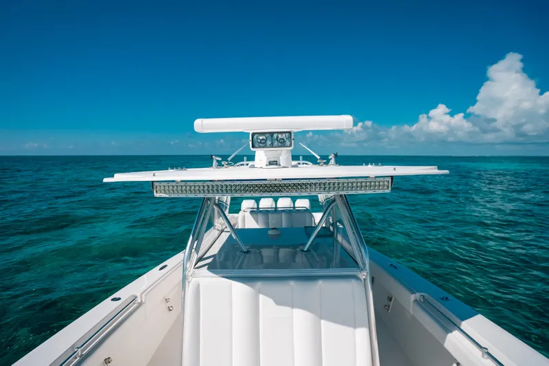 Slide: The Image of 2013 Invincible 42 Open Fisherman boat on clear blue ocean waters. - 25
