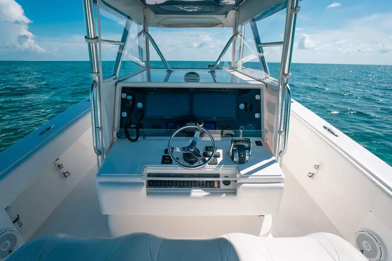 Slide: The Image of 2013 Invincible 42 Open Fisherman boat dashboard with ocean view. - 26