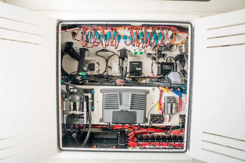 Slide: The Image of Electrical panel of a 2013 Invincible 42 Open Fisherman boat, showcasing wiring and components. - 54