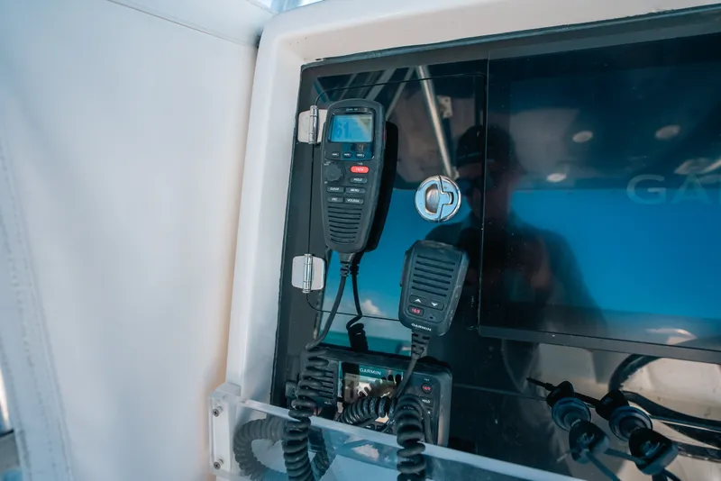 Slide: The Image of Control panel of 2013 Invincible 42 Open Fisherman with Garmin electronics and communication devices. - 36