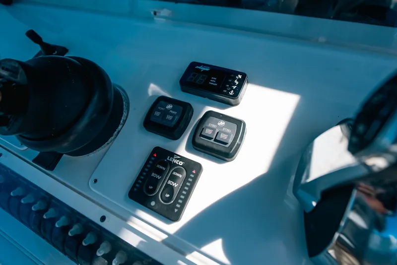 Slide: The Image of Control panel of 2013 Invincible 42 Open Fisherman boat with navigation and trim controls. - 31