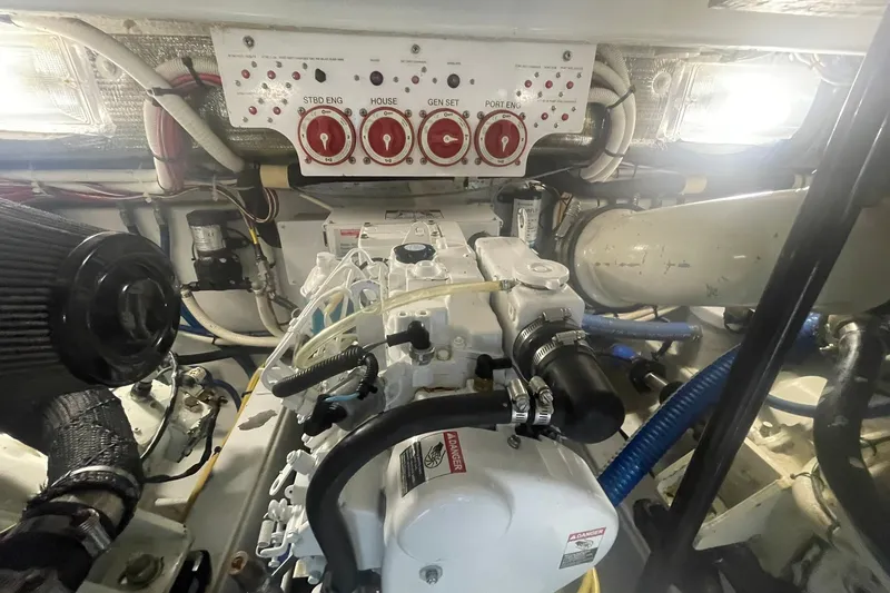 Slide: The Image of Engine room of a 2009 L&H 33 Walkaround boat, featuring control panel and machinery. - 21
