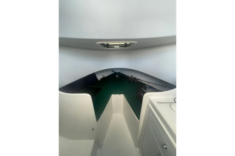 Slide: The Image of Interior view of 2009 L&H 33 Walkaround boat cabin with fishing rods. - 16