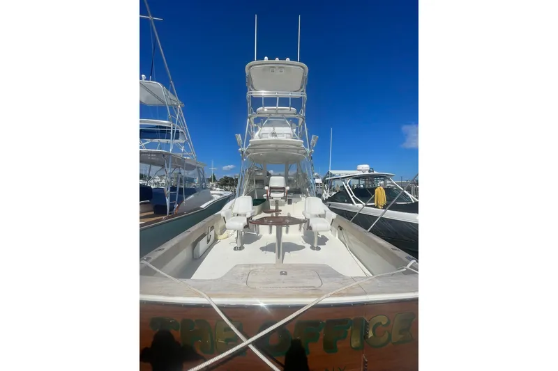 Slide: The Image of 2009 L&H 33 Walkaround boat docked under clear blue sky. - 13
