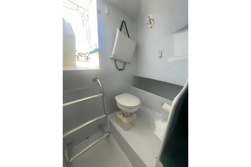 Slide: The Image of 2009 L&H 33 Walkaround boat bathroom with toilet and stainless steel handrail. - 17