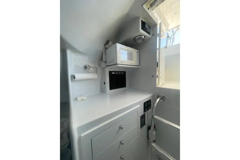 Slide: The Image of Compact interior of 2009 L&H 33 Walkaround with microwave and storage cabinets. - 14