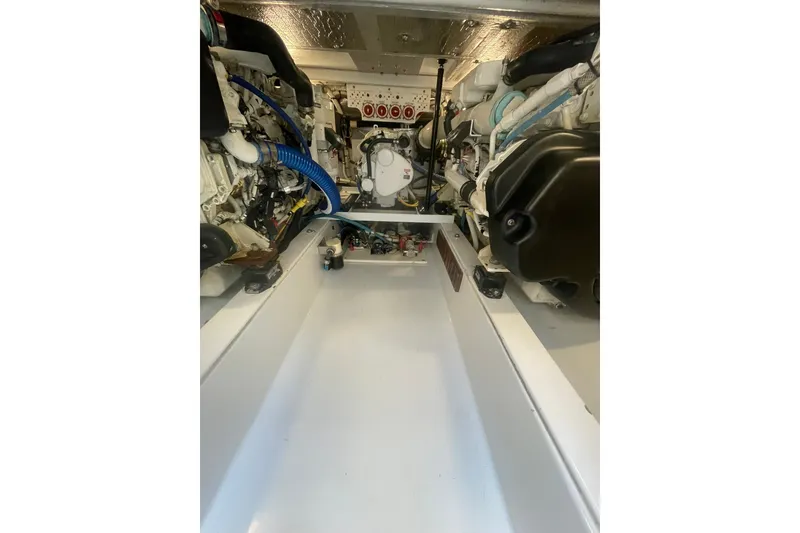 Slide: The Image of Engine room of 2009 L&H 33 Walkaround boat, showcasing mechanical components and layout. - 18