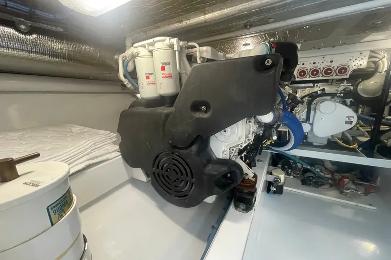 Slide: The Image of Engine room of a 2009 L&H 33 Walkaround boat, showcasing mechanical components. - 19