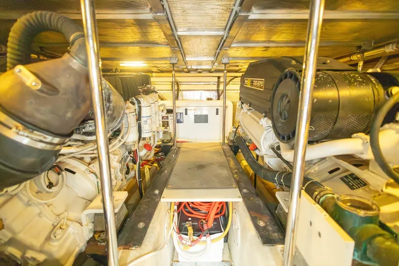 Slide: The Image of Engine room of 2007 Carver 56 Voyager SE yacht, showcasing dual engines and mechanical components. - 42