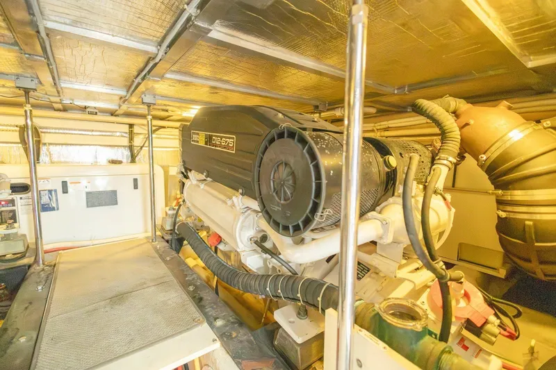 Slide: The Image of Engine room of a 2007 Carver 56 Voyager SE yacht, featuring a D12-575 engine. - 39