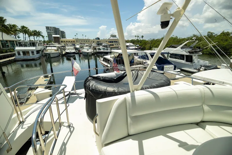 Slide: The Image of 2007 Carver 56 Voyager SE yacht docked at a marina with other boats. - 37