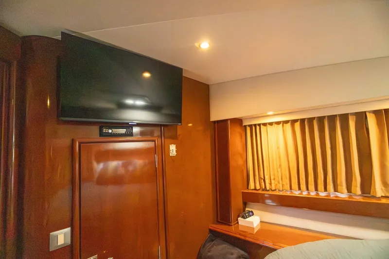 Slide: The Image of Interior of 2007 Carver 56 Voyager SE with TV, wood paneling, and curtains. - 34