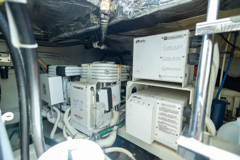 Slide: The Image of Engine room of a 2007 Carver 56 Voyager SE with electrical equipment and wiring. - 44