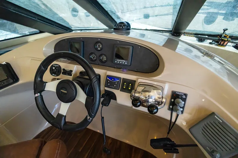 Slide: The Image of 2007 Carver 56 Voyager SE helm with steering wheel and navigation controls. - 20